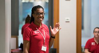 An image of a student waving. 